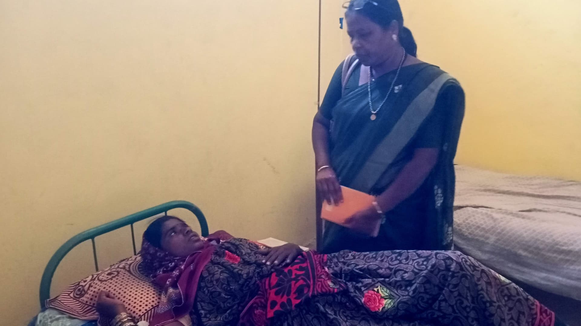 A health worker attending to a woman during a mobile health visit